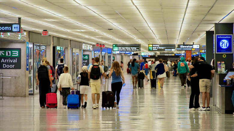 Travelers inside an airport terminal