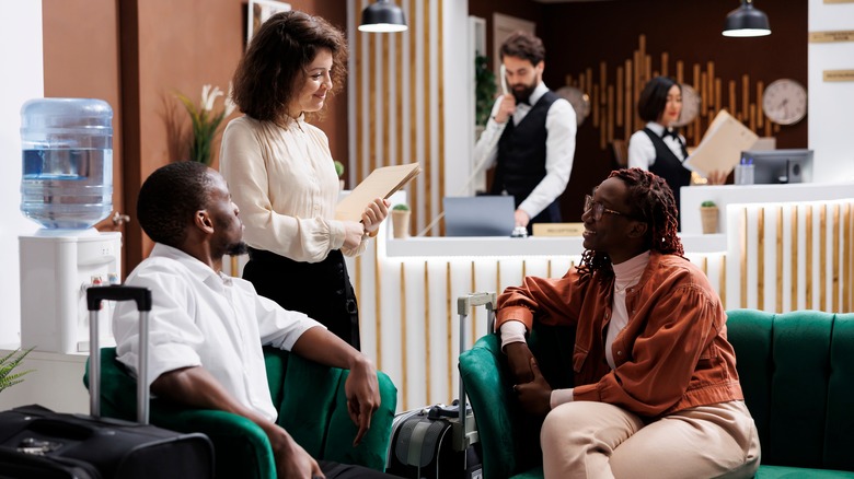 Couple talking to hotel staff