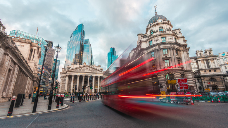 A bus in motion rushing through London's Financial District