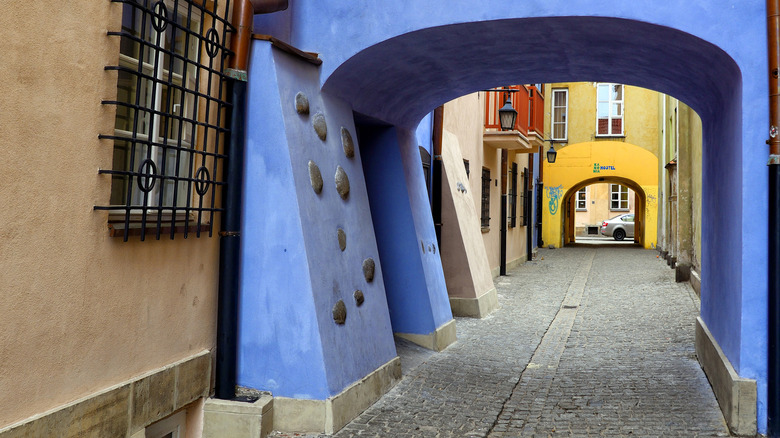 A colorful pedestrian passage with cobbled street in Warsaw, Poland