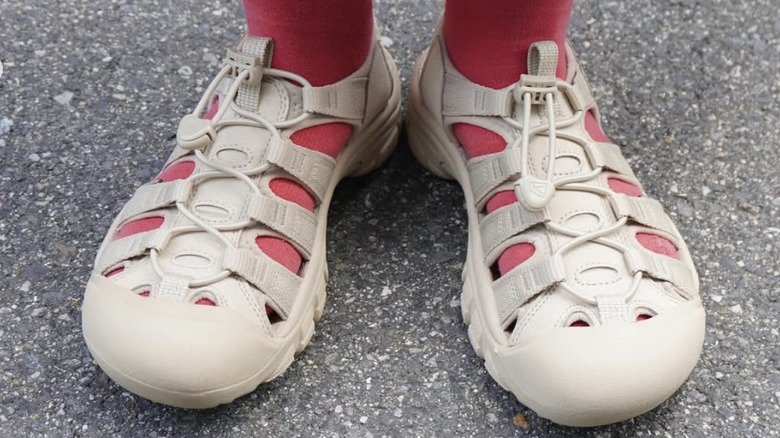 Keen sandals on a woman's feet with red socks