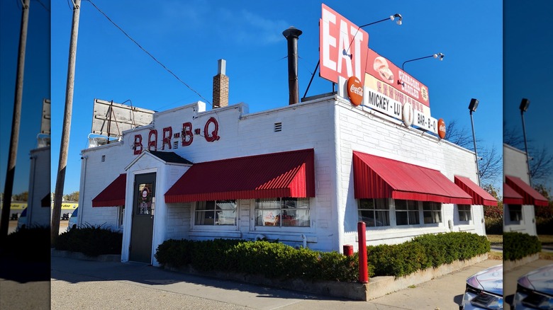 The classic 1940s Mickey-Lu Bar-B-Q. It's a white building with red awnings, large BAR-B-Q letters, and an old sign promoting the charcoal broiled burgers