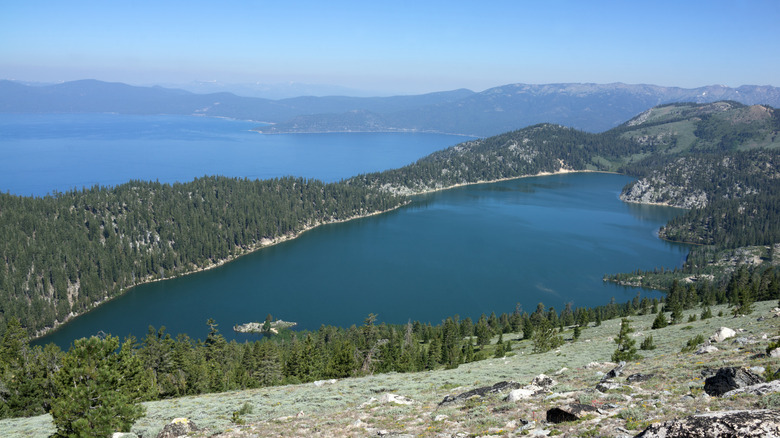 Marlette Lake pictured from above, with surrounding trees and fog in the distance