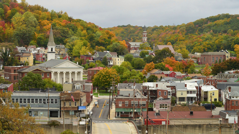 View of downtown Cumberland, Maryland surrounded by a mountainous forest landscape, on an overcast day