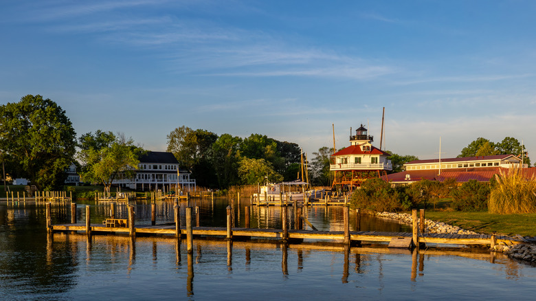 Drum Point Lighthouse by waterfront on sunny day