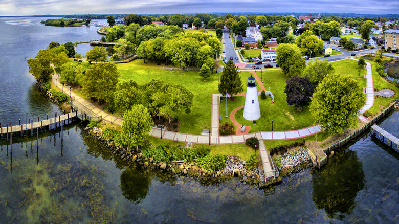 Green space and water around Concord Point Lighthouse, with tree-lined residential streets in the background