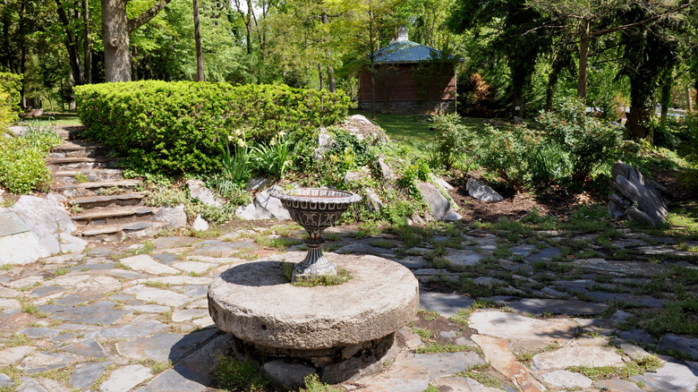 A stone fountain and stairs surrounded by trees in Hagerstown City Park.