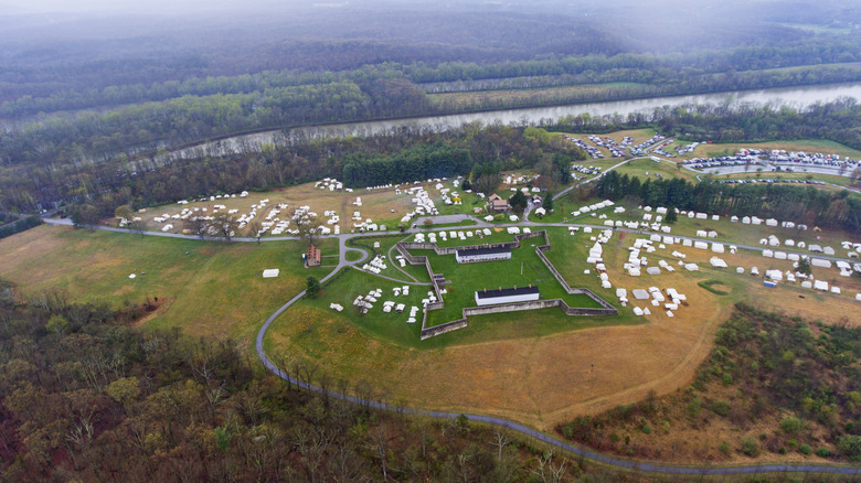 An aerial view of the historic Fort Frederick in a sprawling state park surrounded by a river and forests.