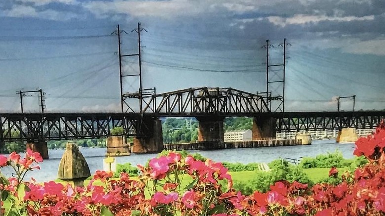Painting of bridge against a cloudy sky