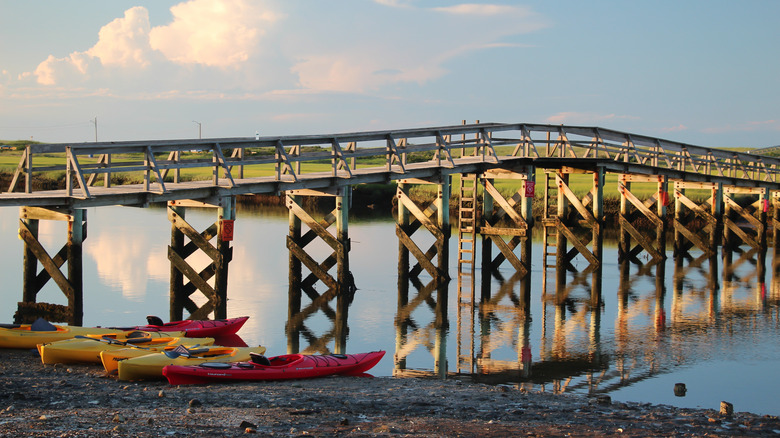Kayaks parked next to the Sandwich Boardwalk at sunset