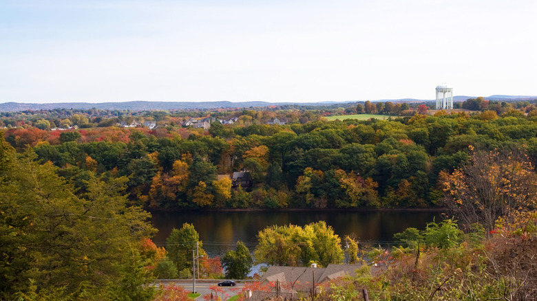An aerial view of Ludlow, along the Chicopee River, during fall foliage in Massachusetts
