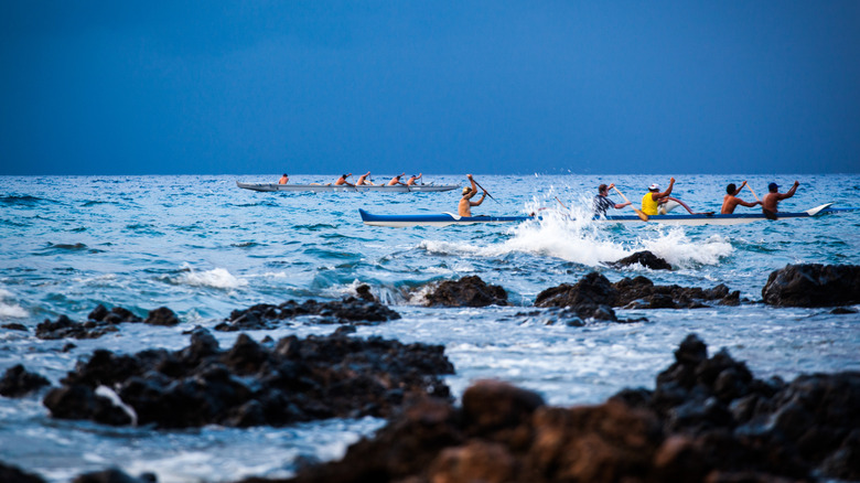 A group of men canoeing along the coast of Kihei