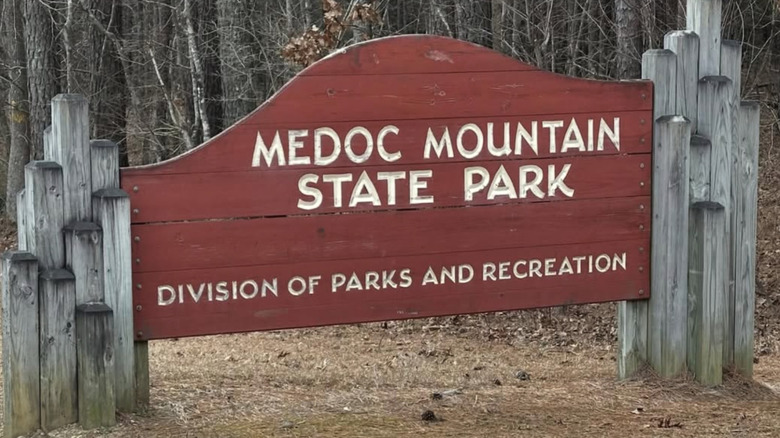 A rustic wooden sign that reads MEDOC MOUNTAIN STATE PARK DIVISION OF PARKS AND RECREATION
