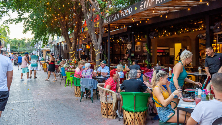 American tourists sit at an outdoor restaurant in Quintano Roo, Mexico
