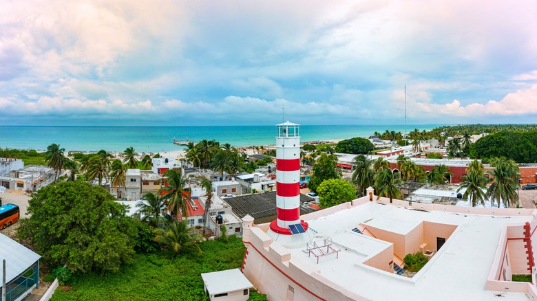 A lighthouse overlooking the coast and turquoise water of Sisal, Mexico