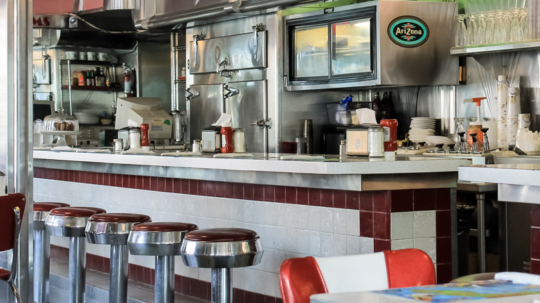 The interior of the 11th Street Diner in Miami, Florida, with a bar and barstools