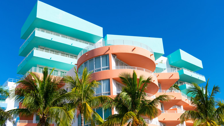 Colorful buildings and palm trees against a blue sky