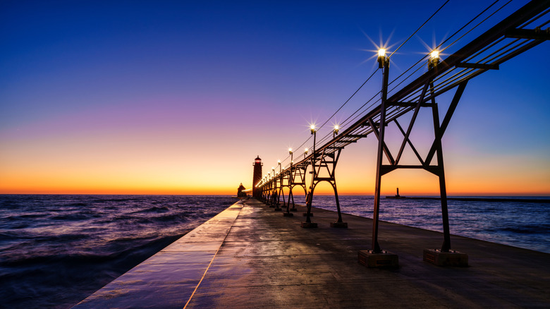 Michigan's Grand Haven Pier at dusk, with Lake Michigan in the distance