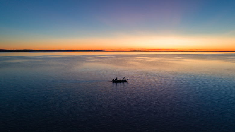 A small fishing boat on Houghton Lake in Michigan at sunrise