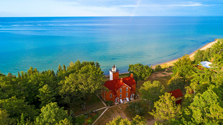 Red-bricked 40 Mile Point Lighthouse with Lake Huron in the background