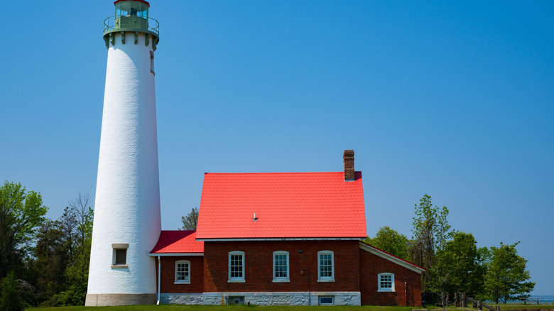 The house and tower of historic Tawas Point Lighthouse in Tawas Point State Park in Michigan