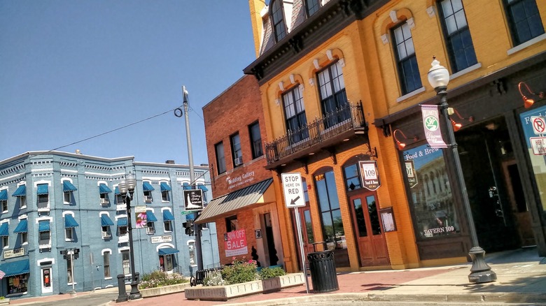 The colorful historic buildings along a street in downtown Williamston, Michigan