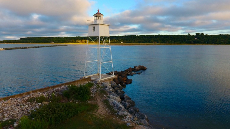 A lighthouse with a lake in the background in Grand Marais, Michigan
