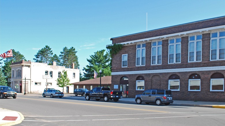 A sunny summer day on the quiet streets of downtown Gwinn with brick buildings and cars parked along the curb