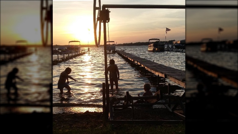 Silhouettes of kids playing at the marina during sunset at Manitou Beach-Devils Lake