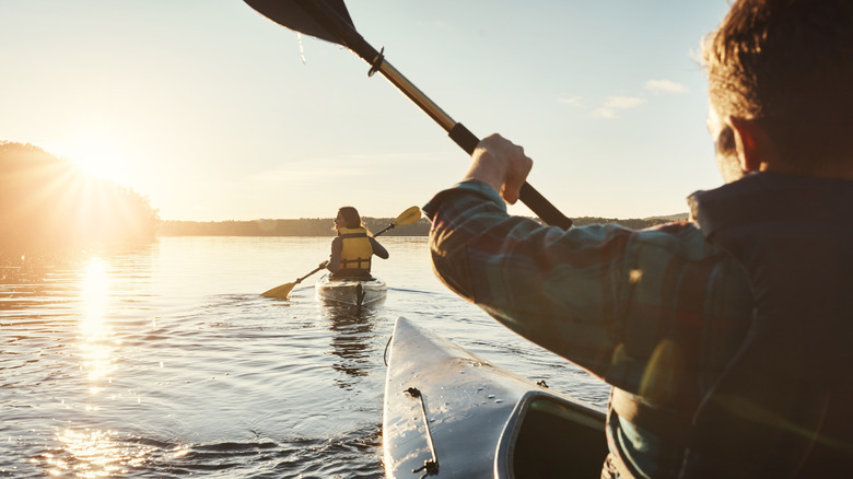 Man and woman kayaking on river