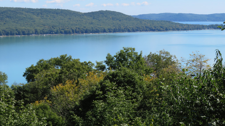 View of green hills and Lake Michigan's blue water from an overlook at Pierce Stocking Scenic Drive