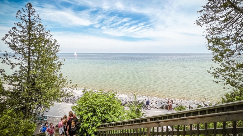 A group of people walking near the harbor in Mackinac Island State Park