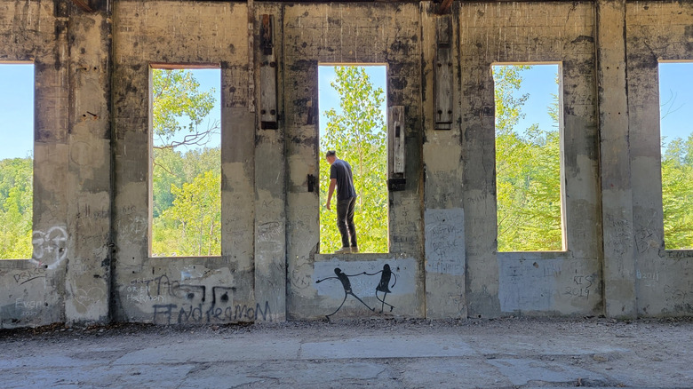 A man standing at a location within the Fiborn Karst Preserve, Michigan