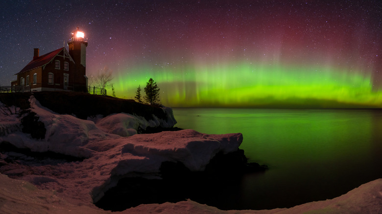 lighthouse and purple and green northern lights