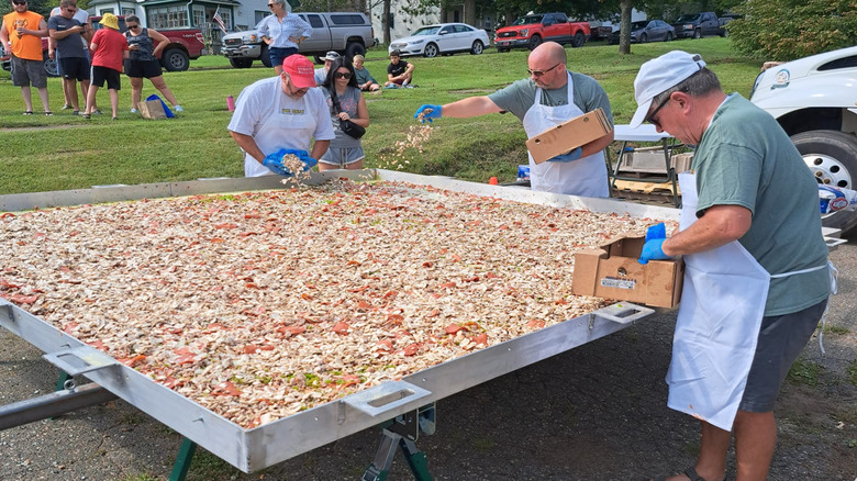 Volunteers assemble the 10 foot by 10 foot pizza