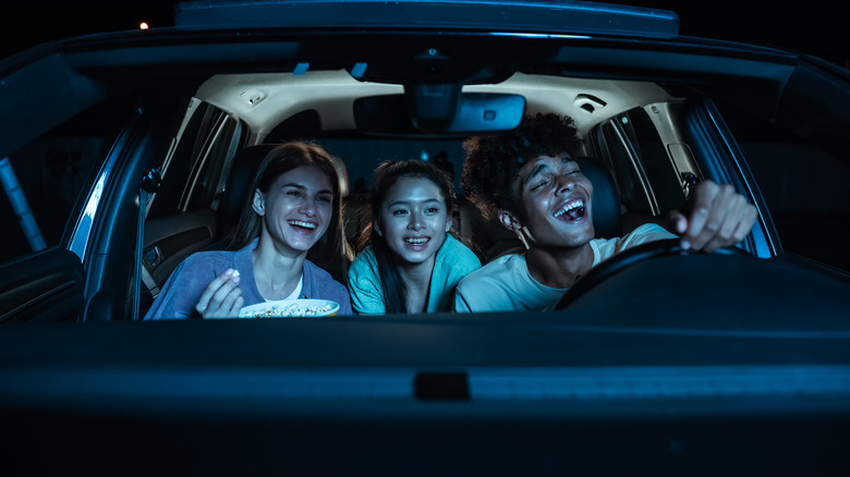 Three friends at a drive-in theater