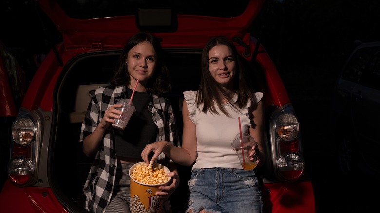 Friends sharing snacks at a drive-in theater