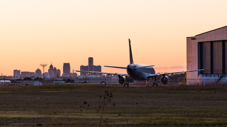 Airplane parked in front of city skyline