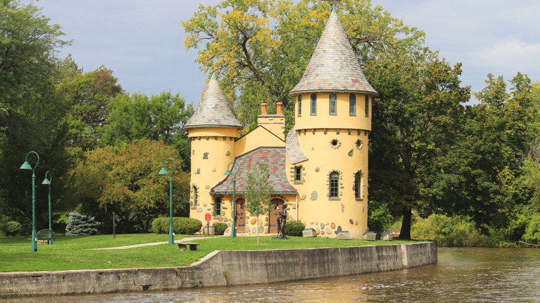Owosso Curwood Castle sits on the bank of the Shiawassee River on a sunny day
