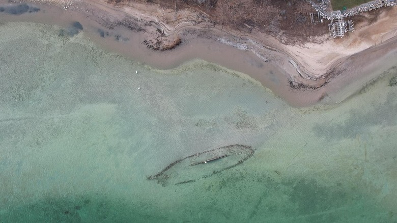 Outline of shipwreck in shallow water