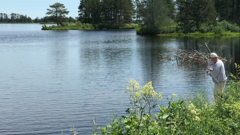 A man fishing from the shore at Seney National Wildlife Refuge in the Upper Peninsula of Michigan