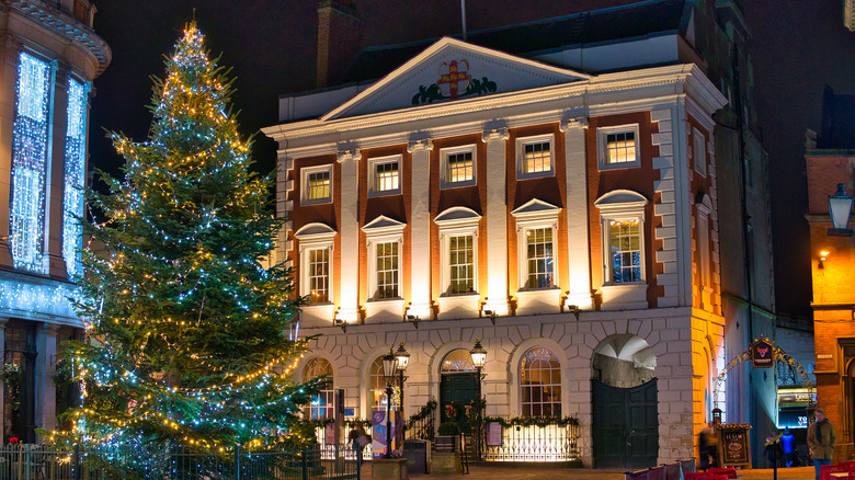 Christmas tree in front of red Georgian building