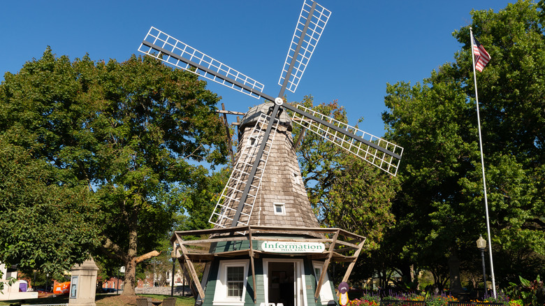 A traditional wooden windmill in a park