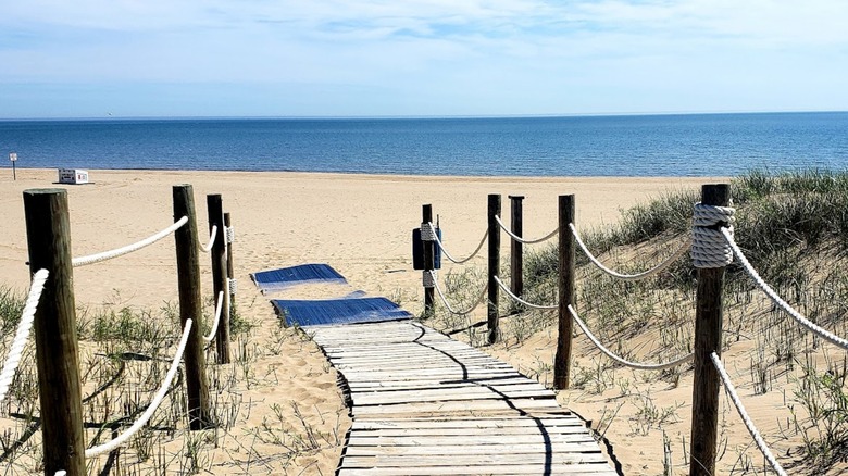 A woman and child walking down a boardwalk to North Beach Park in Racine, Wisconsin