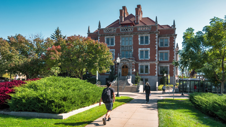 Students walk around Folwell Hall at the University of Minnesota Twin Cities in Minneapolis