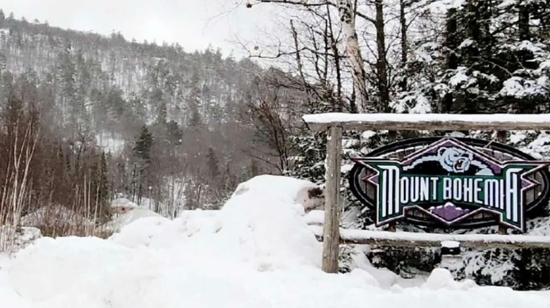 A snow-covered entrance sign in Mount Bohemia, Michigan