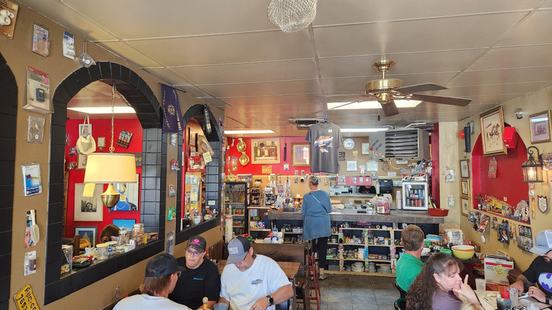 Interior of The Cracked Egg with patrons dining and funky decor on the walls