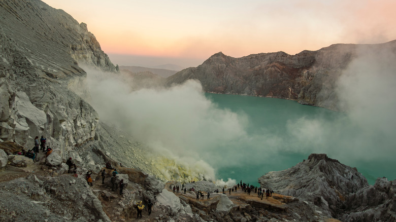 Tourists surrounding the crater lake in the stratovolcano Mount Ijen, on Java island, Indonesia