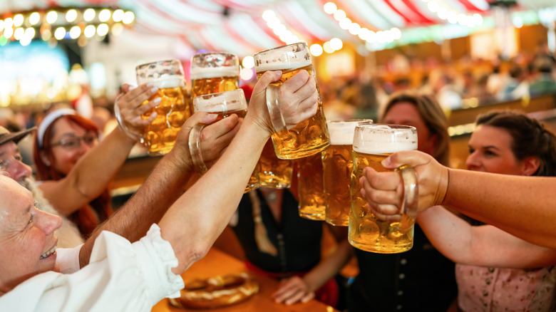 Group of people cheering beer masses during Oktoberfest celebrations