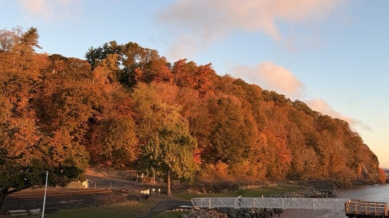 Milton Landing Park and pier on Hudson River surrounded by fall foliage in Hudson Valley, New York